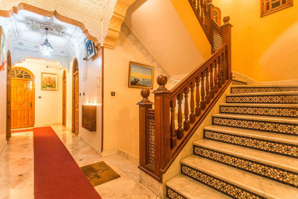 a staircase in a home with yellow walls at Hotel Borj Mogador in Essaouira