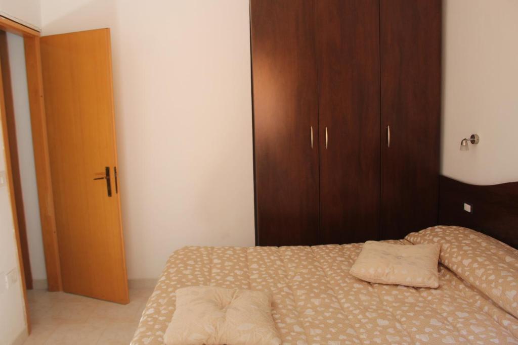 a bedroom with a bed with two pillows on it at Residence Hotel Torresilvana in Vieste