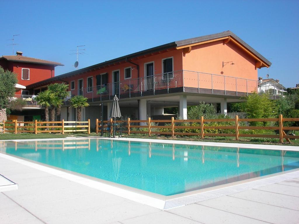 a swimming pool in front of a building at Agriturismo Al Dugale in Lazise