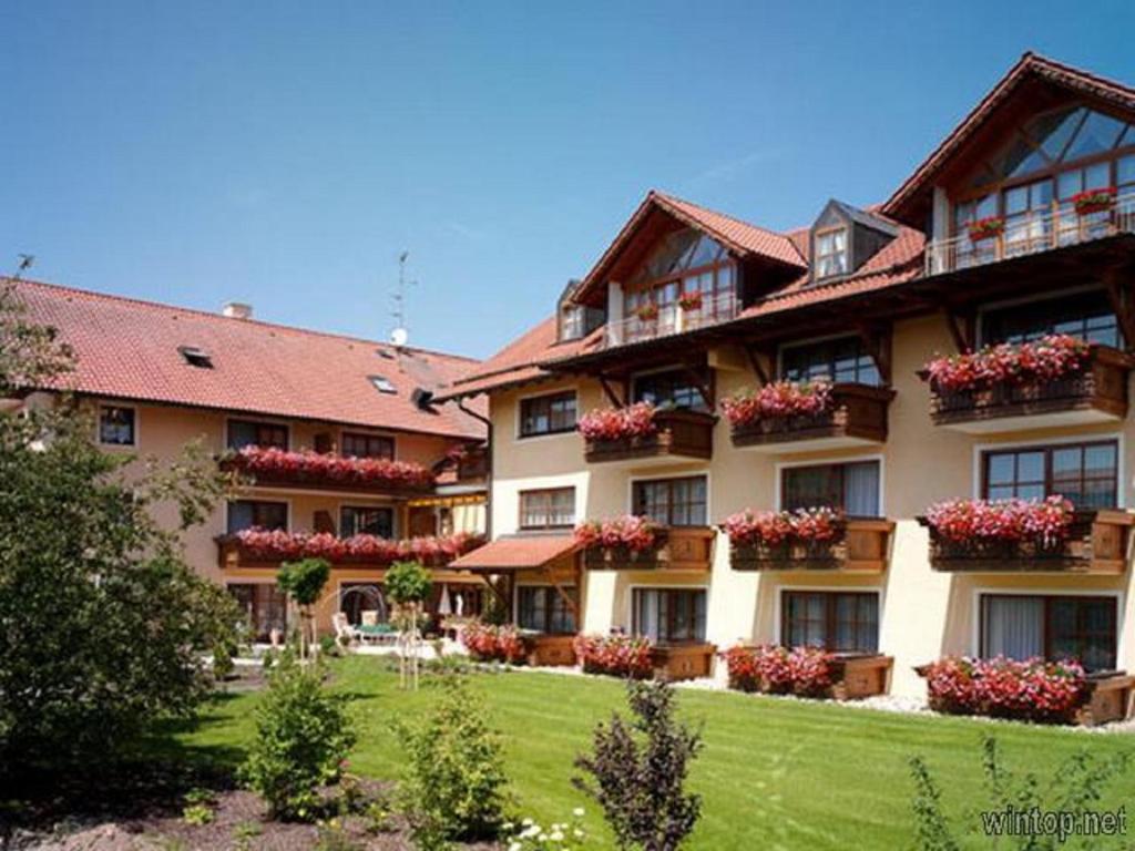 a large building with flower boxes on the windows at Appartementhaus Holmernhof I in Bad Füssing