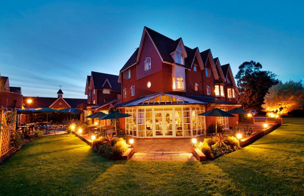 a large building with lights in front of it at Hempstead House Hotel & Restaurant in Sittingbourne