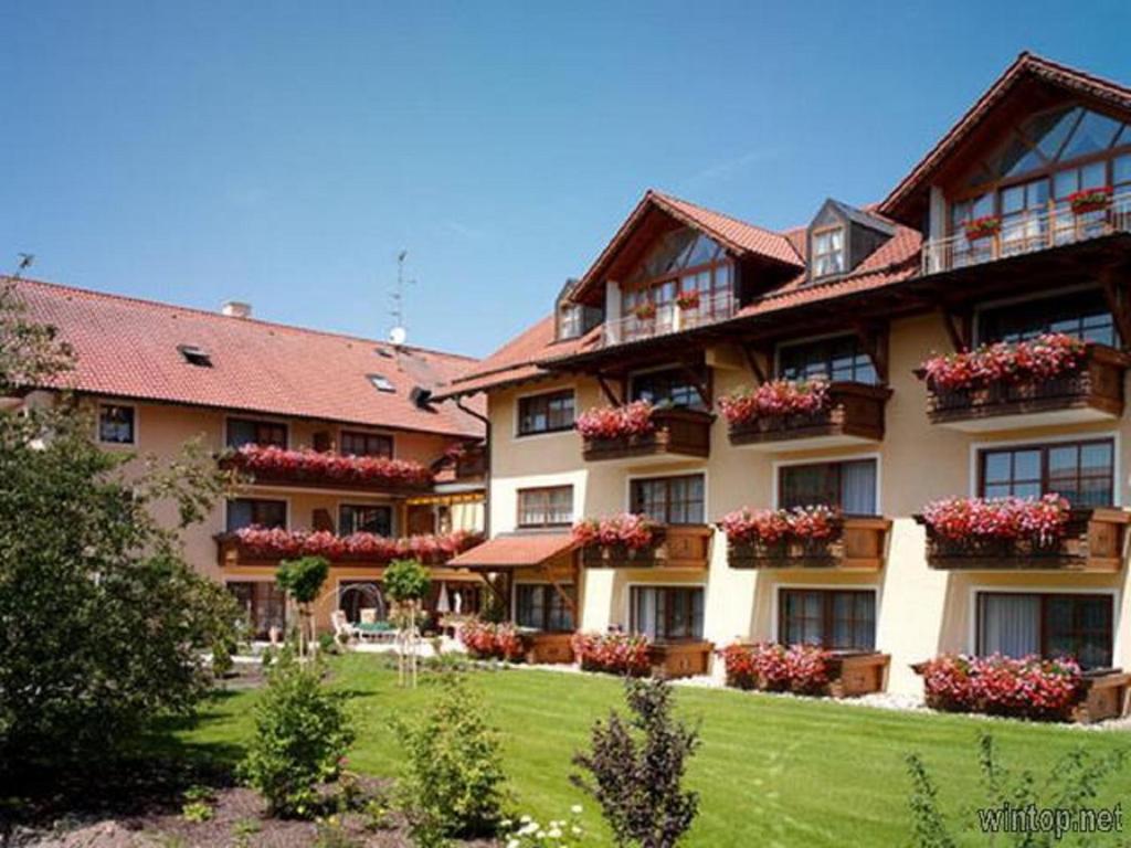 a large building with flower boxes on the windows at App.-Haus Holmernhof II in Bad Füssing