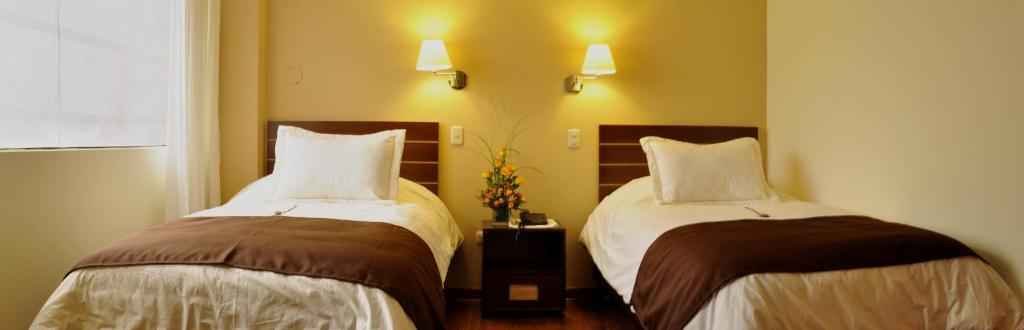Postel nebo postele na pokoji v ubytování Kapac Inn Hotel