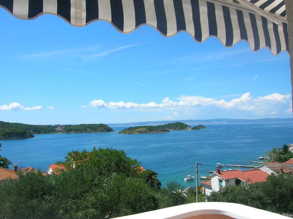 a view of a large body of water with islands at Apartment Jelena in Rab