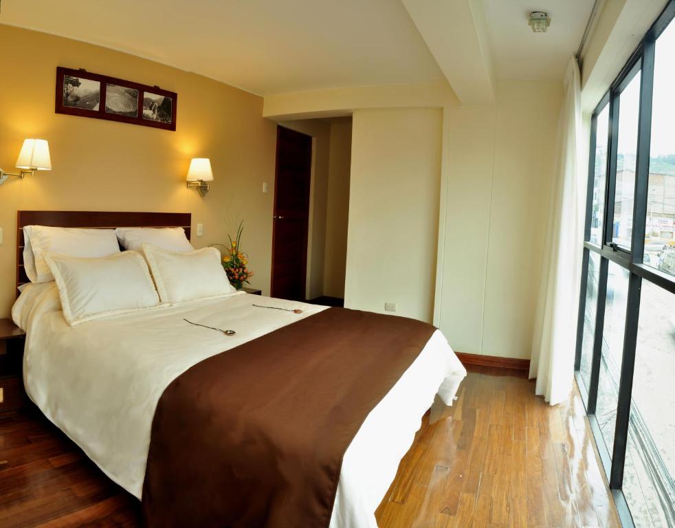 Postel nebo postele na pokoji v ubytování Kapac Inn Hotel