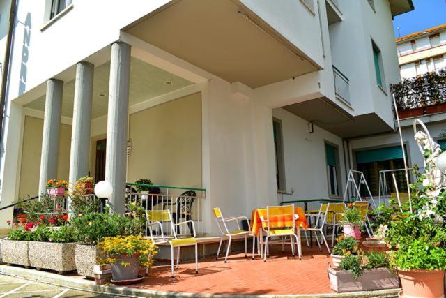 an outdoor patio with chairs and tables and plants at Pensione Andrea in Chianciano Terme