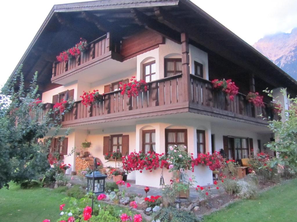 a house with flowers in front of it at Landhaus Sailer in Mittenwald