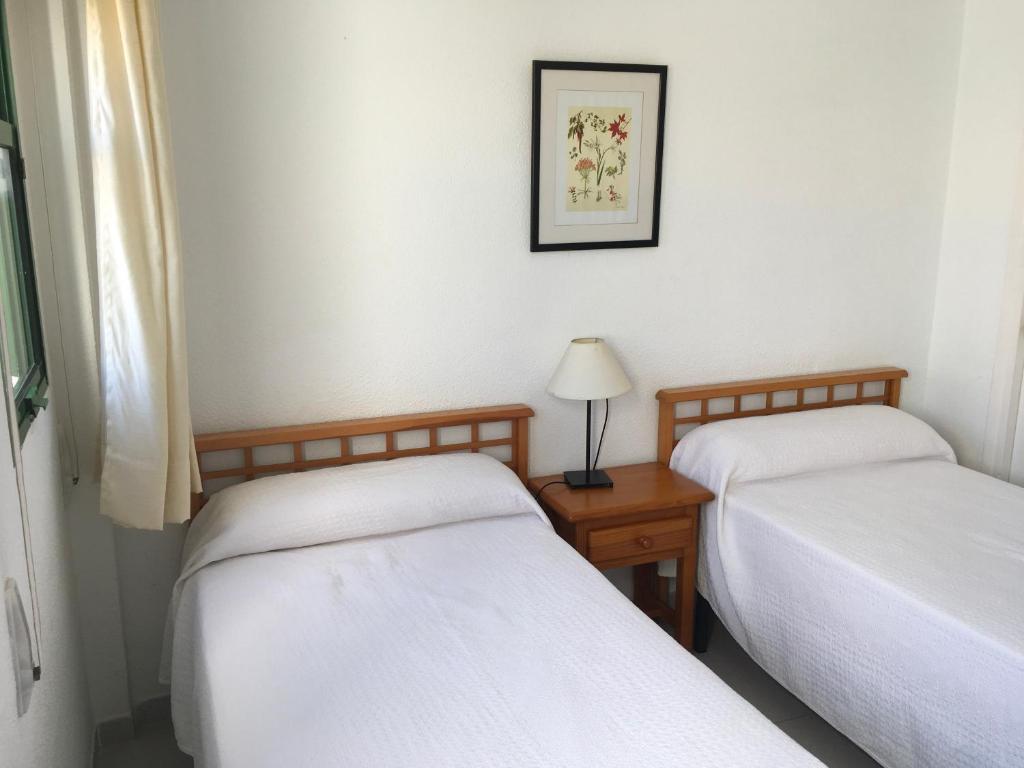 Cama o camas de una habitación en Apartamentos Torrelaguna