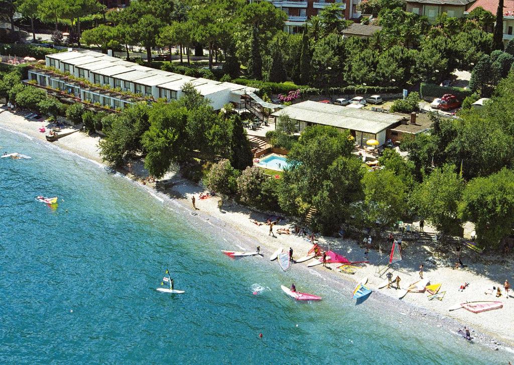 an aerial view of a beach with people in the water at Hotel Lido in Limone sul Garda