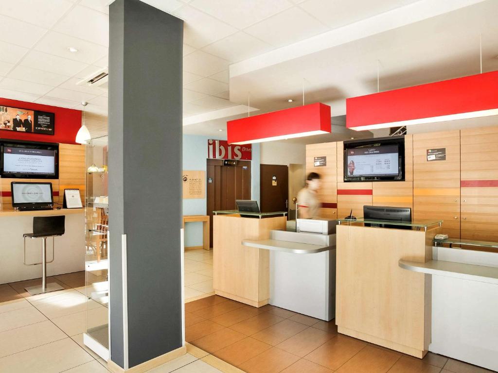 a hospital reception area with a person in the background at Ibis Brive Centre in Brive-la-Gaillarde