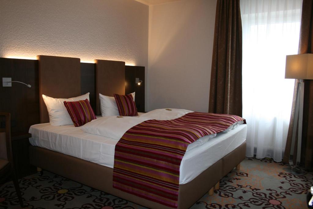 Postel nebo postele na pokoji v ubytování HOTEL PARQÉO im A66