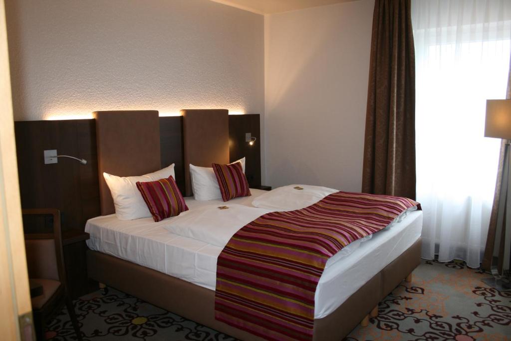 Postel nebo postele na pokoji v ubytování HOTEL PARQÉO im A66