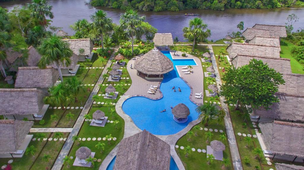 an aerial view of a resort with a swimming pool at Irapay Amazon Lodge - Asociado Casa Andina in Padre Cocha