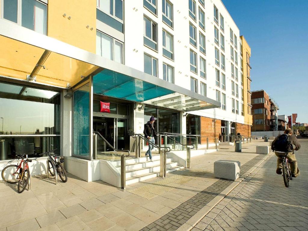 a building with people riding bikes outside of it at ibis Bristol Temple Meads in Bristol
