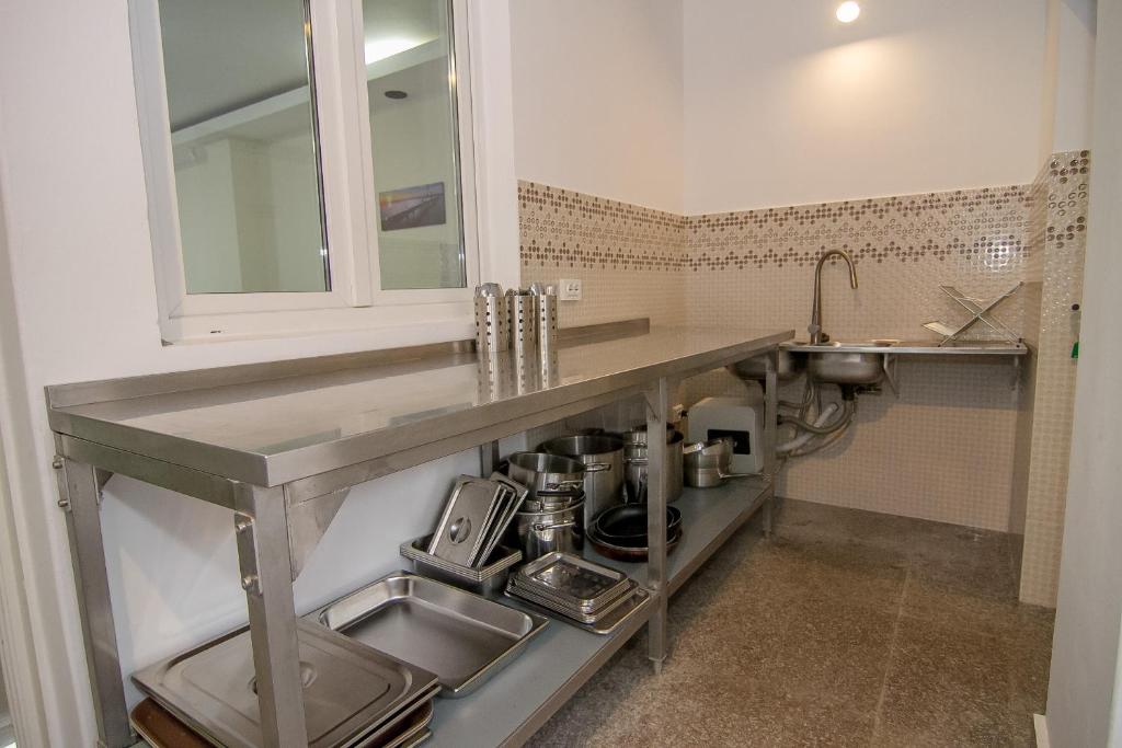 a kitchen with a sink and a counter top at Hotel MaRailiS Mangalia in Mangalia