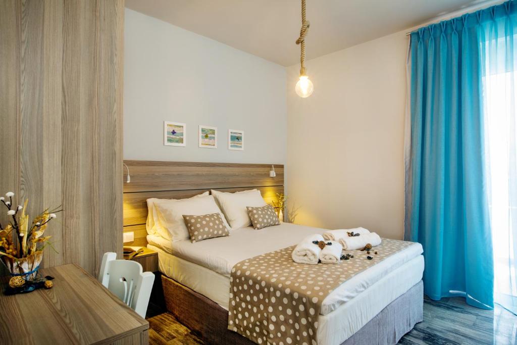 a bedroom with a bed with two stuffed animals on it at Beachside Apartment in Plakias centre! in Plakias
