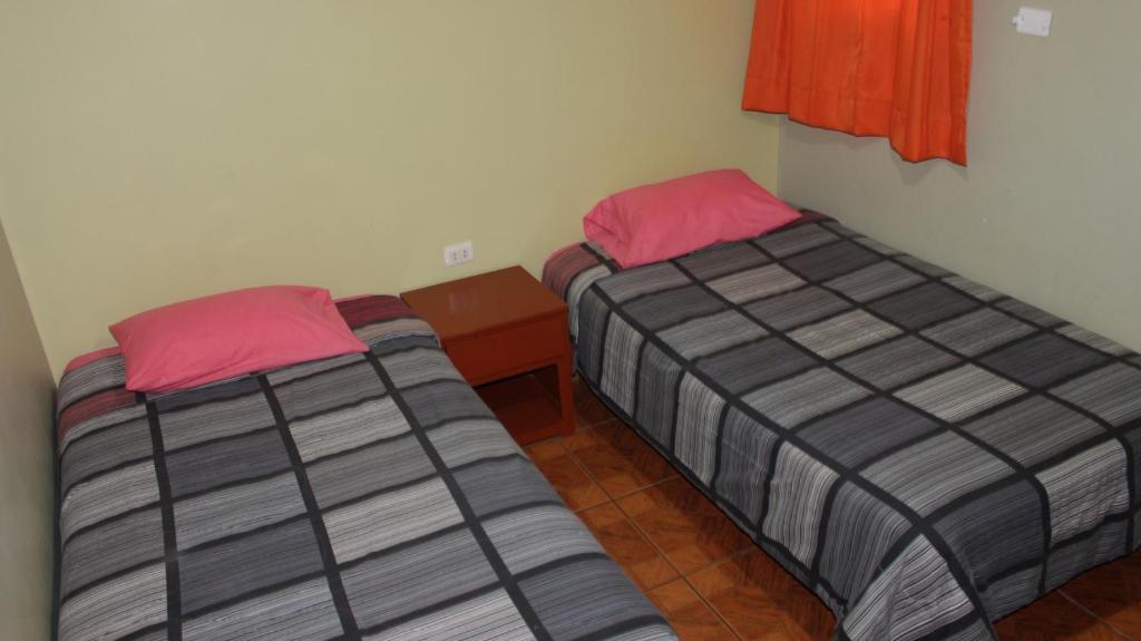 Postel nebo postele na pokoji v ubytování Hostal Aventura