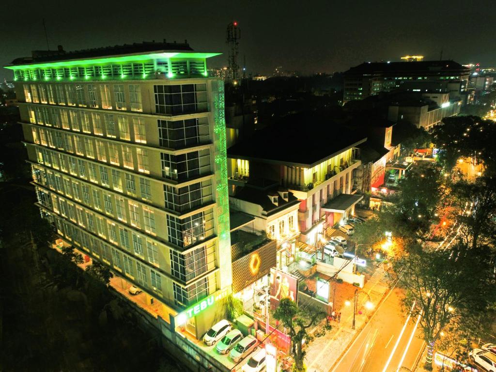 ein hohes Gebäude mit grüner Beleuchtung darüber in der Unterkunft Tebu Hotel Bandung in Bandung