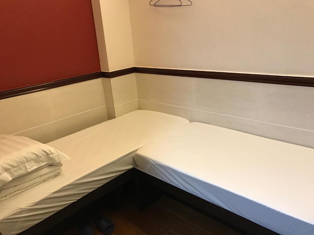 Voodi või voodid majutusasutuse Lap Shun Hostel toas