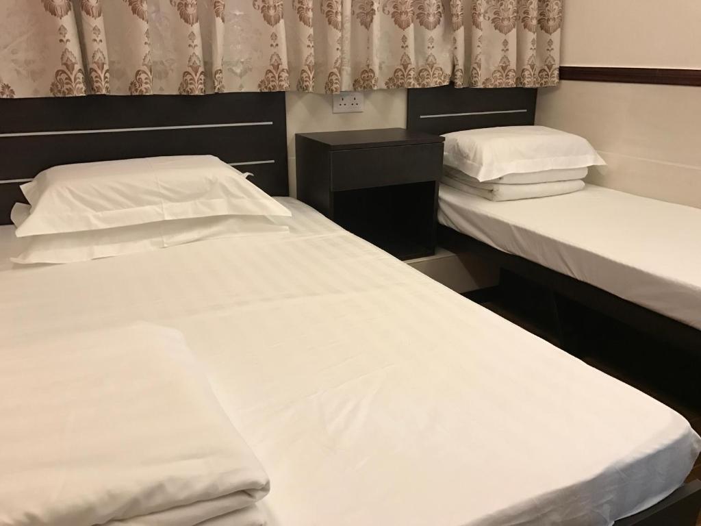 Voodi või voodid majutusasutuse Lap Shun Hostel toas
