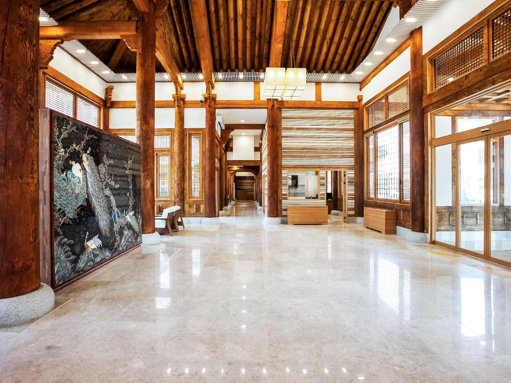 a large room with wooden ceilings and a large wall of windows at Gyeongwonjae Ambassador Incheon Associated with Accor in Incheon