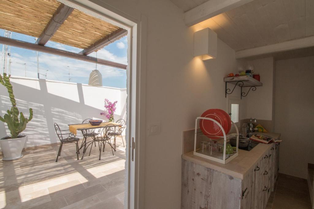 a kitchen with a view of a patio with a table at Casa Martina in Monopoli