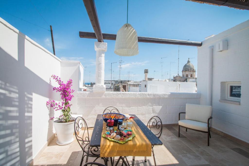 a table and chairs on a balcony with a view of the city at Casa Martina in Monopoli