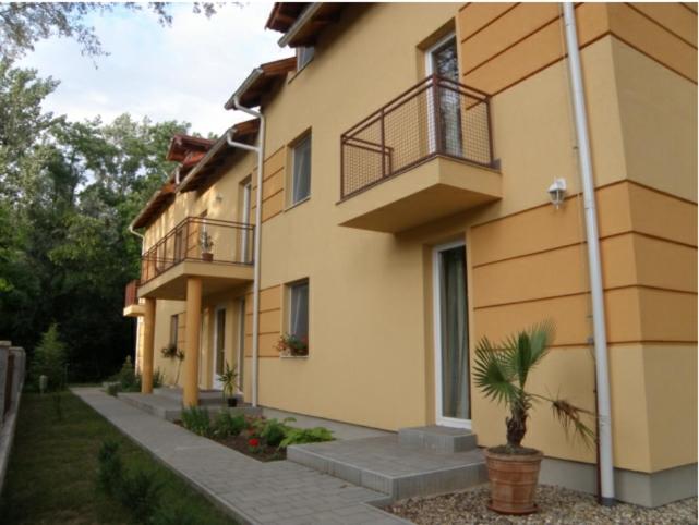 a building with a potted plant in front of it at Anker Villa in Balatonszárszó