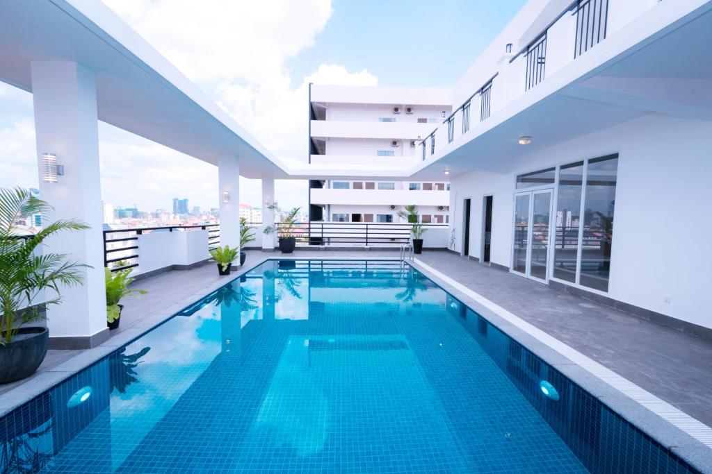 a swimming pool in the middle of a house at Sun Apartment in Phnom Penh
