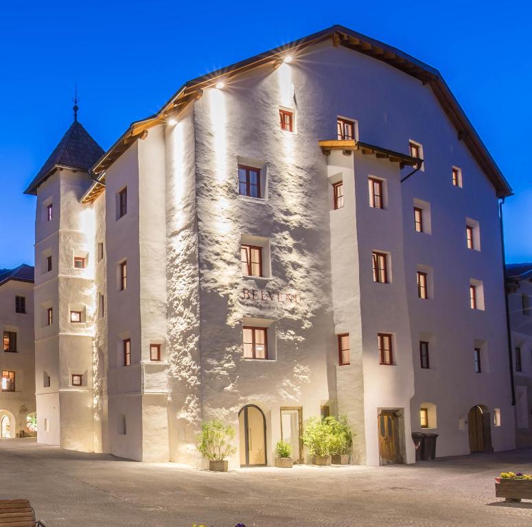 a large white building with a tower at Belvenu Boutique Hotel in Glorenza