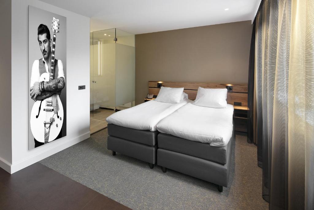 Postel nebo postele na pokoji v ubytování Theaterhotel Venlo