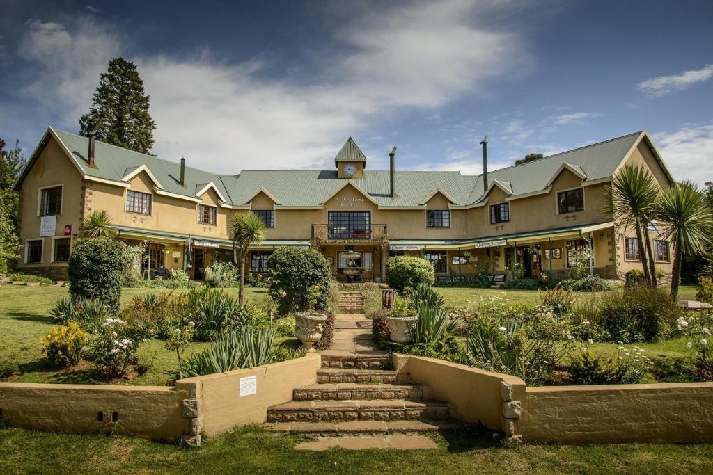 a large house with a garden in front of it at Auldstone House in Dullstroom