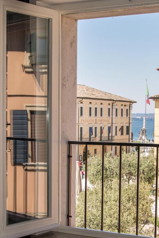 a window with a view of a building at IN PIAZZA appartamento con vista in Lazise