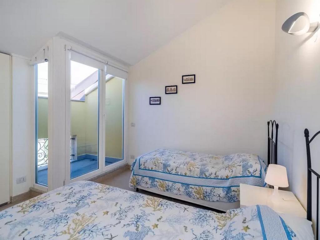 a bedroom with two beds and a window at Libra Flexyrent in Rapallo