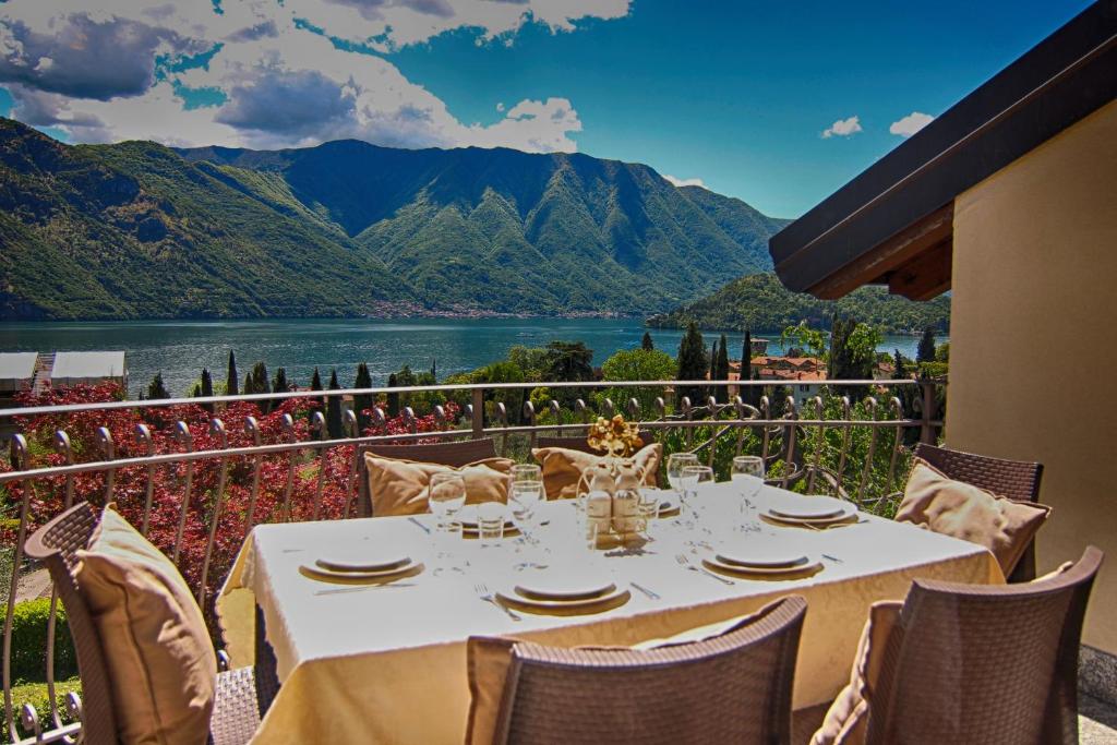 a table on a balcony with a view of a lake at Casa Meraviglia in Tremezzo