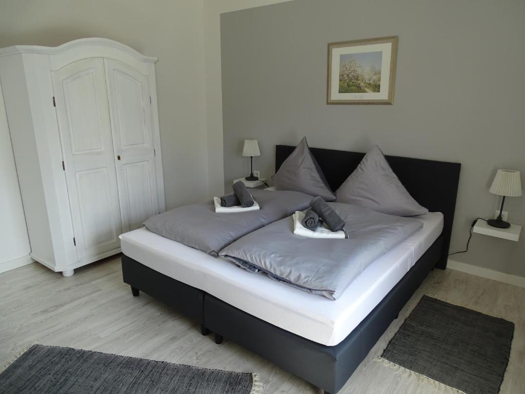 a bedroom with a bed with two pillows on it at Gästehaus Schwentineblick in Malente