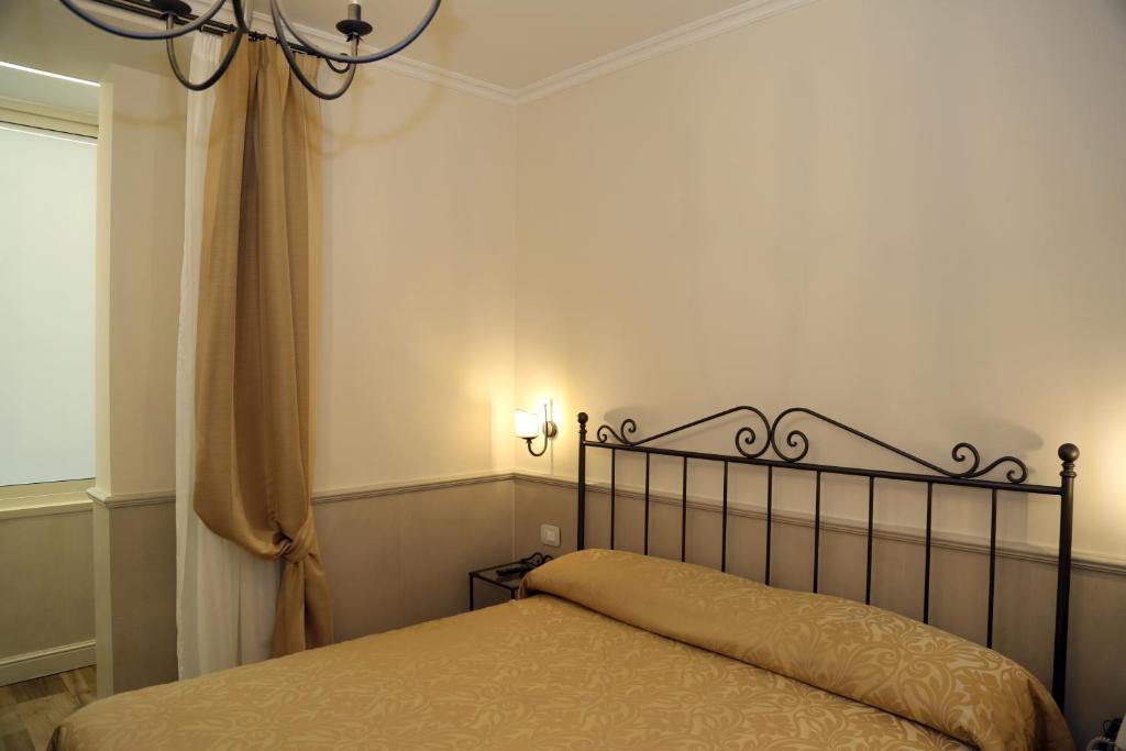 Postel nebo postele na pokoji v ubytování Hotel Flavia