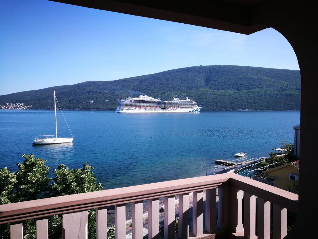 a cruise ship on a large body of water at Vila Jadranka Apartments in Herceg-Novi