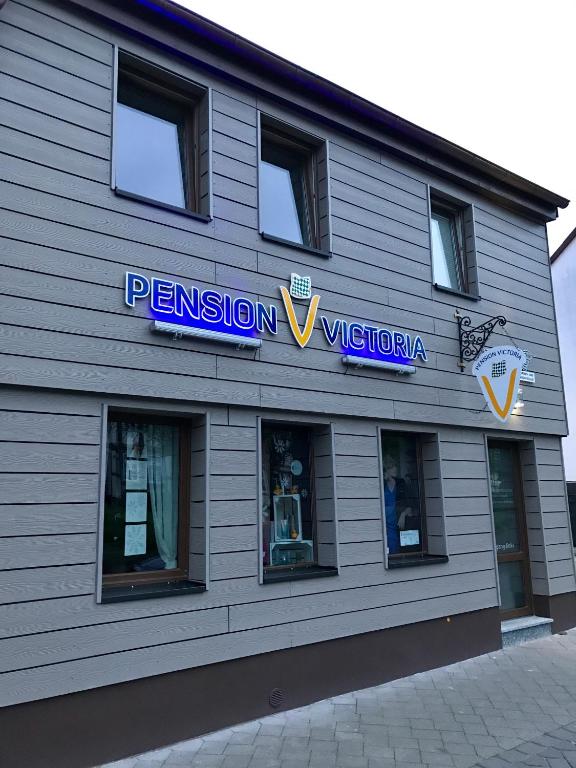 a building with a sign on the side of it at Pension Victoria Halberstadt in Halberstadt
