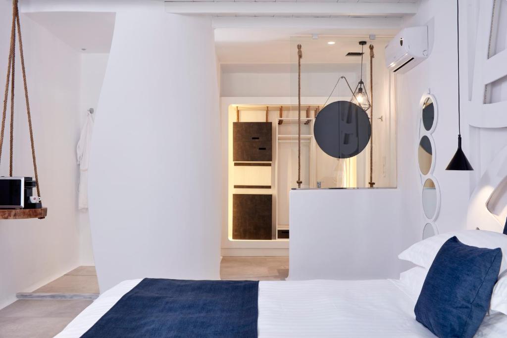 A bed or beds in a room at Absolute Mykonos Suites & More