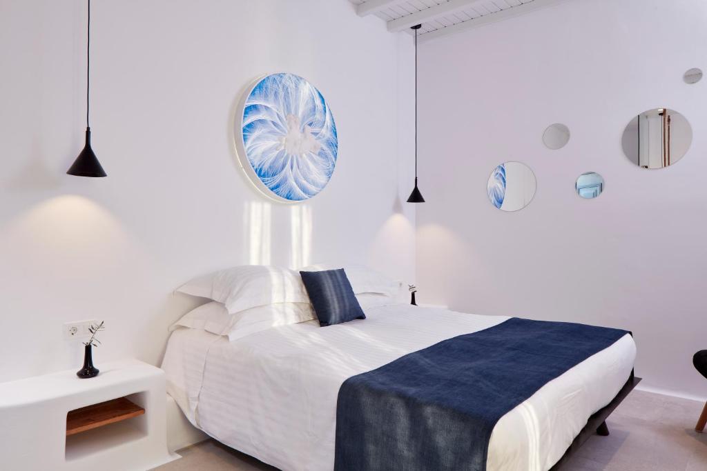 A bed or beds in a room at Absolute Mykonos Suites & More