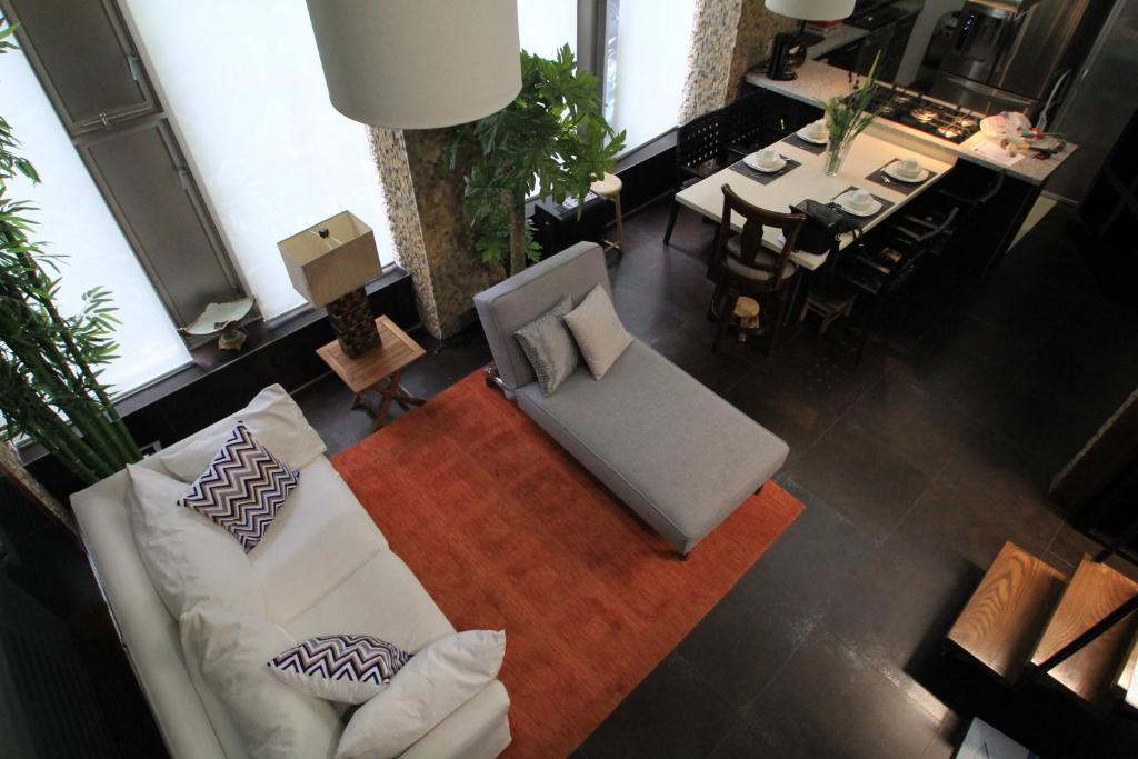 a living room with a white couch and a table at Boutique Apartment PBK in Mexico City