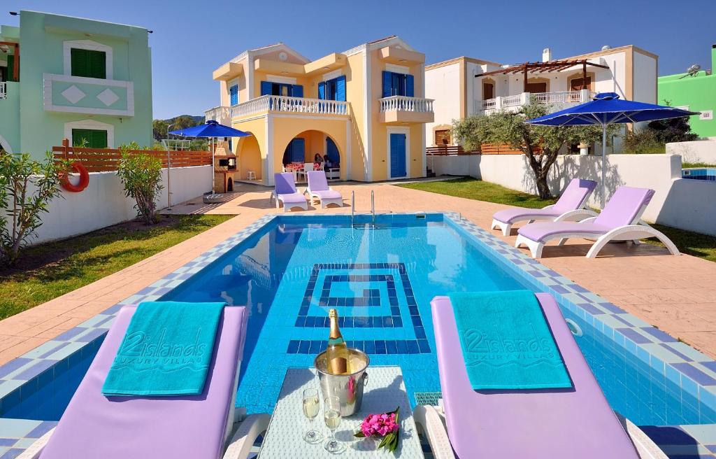 a villa with a swimming pool and a house at 12 Islands Villas in Kolymbia