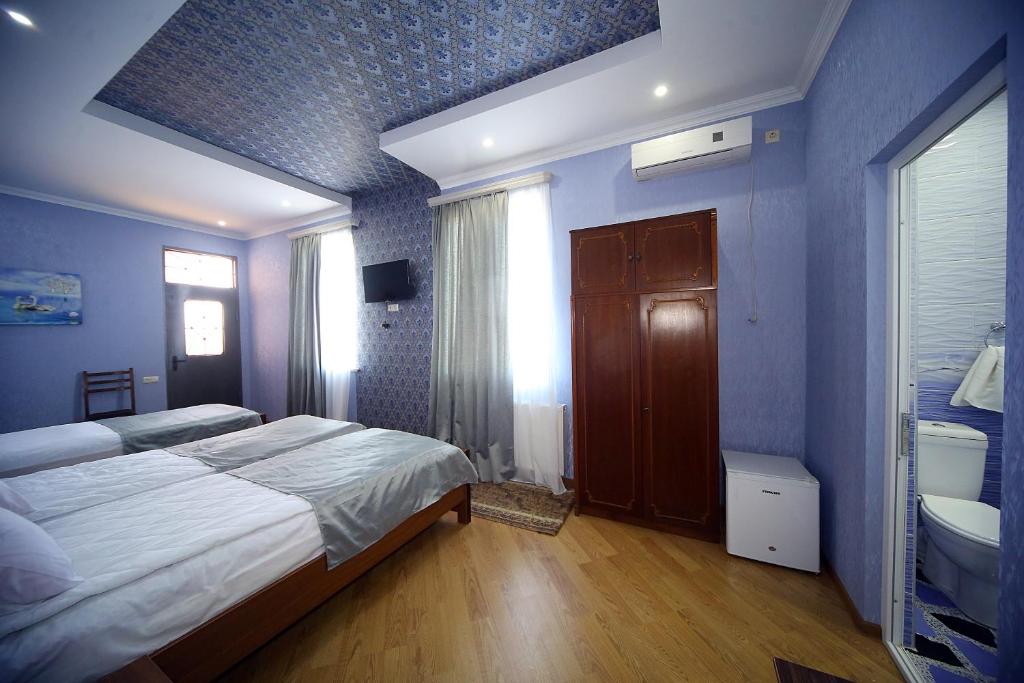 Postel nebo postele na pokoji v ubytování Hotel Harmony