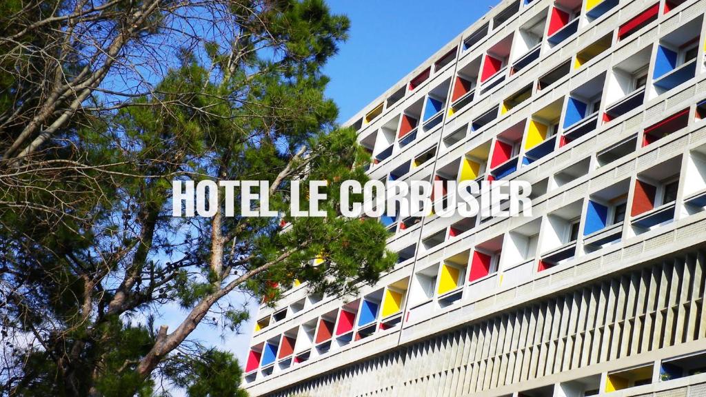 a building with colorful flags on the side of it at Hotel le Corbusier in Marseille