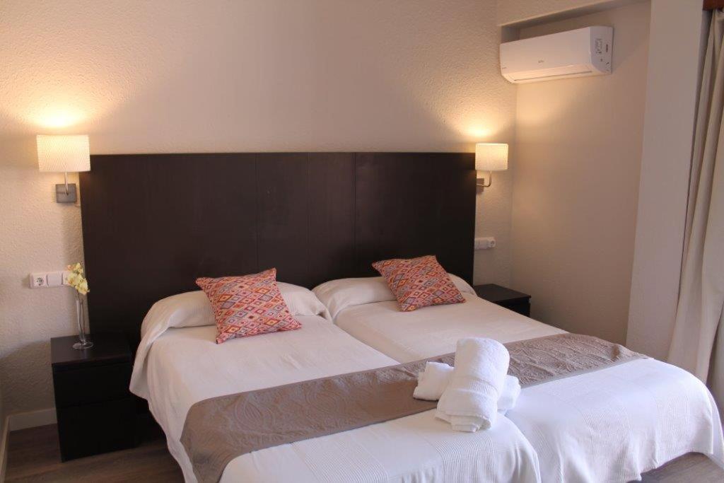 Postel nebo postele na pokoji v ubytování Hostal Jakiton