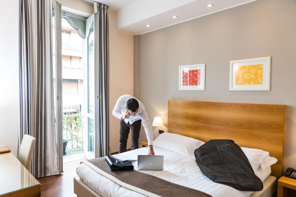 Postel nebo postele na pokoji v ubytování Hotel Royal Falcone