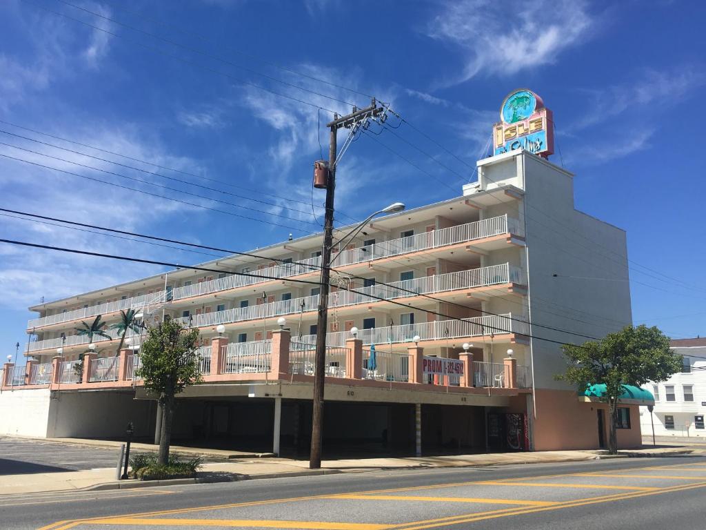 a large white building with a sign on top of it at Isle of Palms Motel in Wildwood