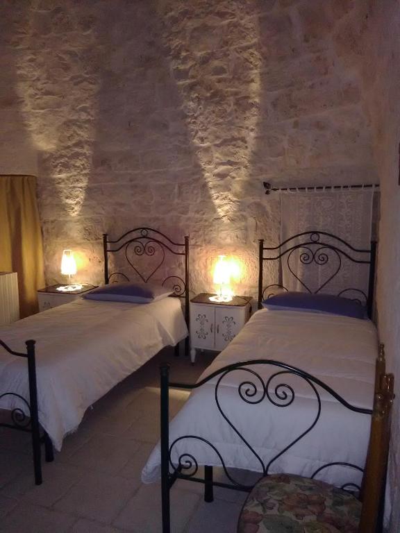 A bed or beds in a room at Trulli Sarmenzanello