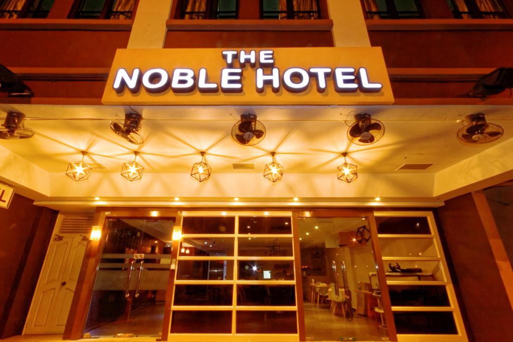 a sign for the mole hotel at night at The Noble Hotel in Singapore